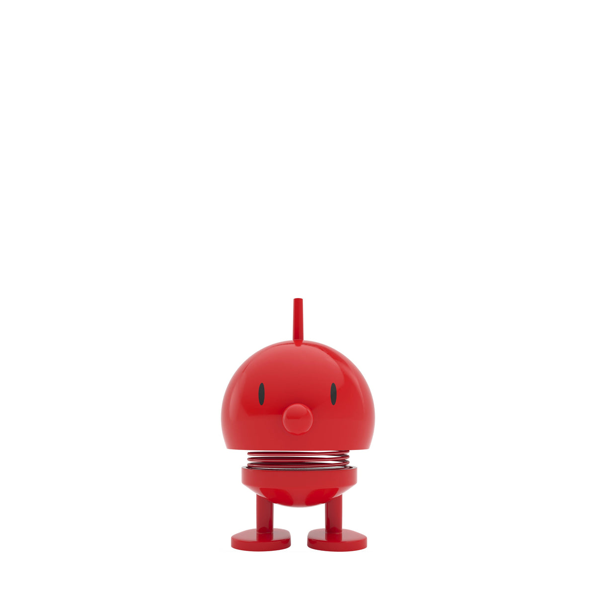 A small red toy figure with a round head, simple facial features, and short legs, centered on a plain white background.