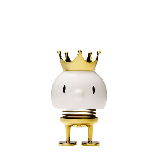 Decorative object with a white sphere, gold crown, and legs on a white background
