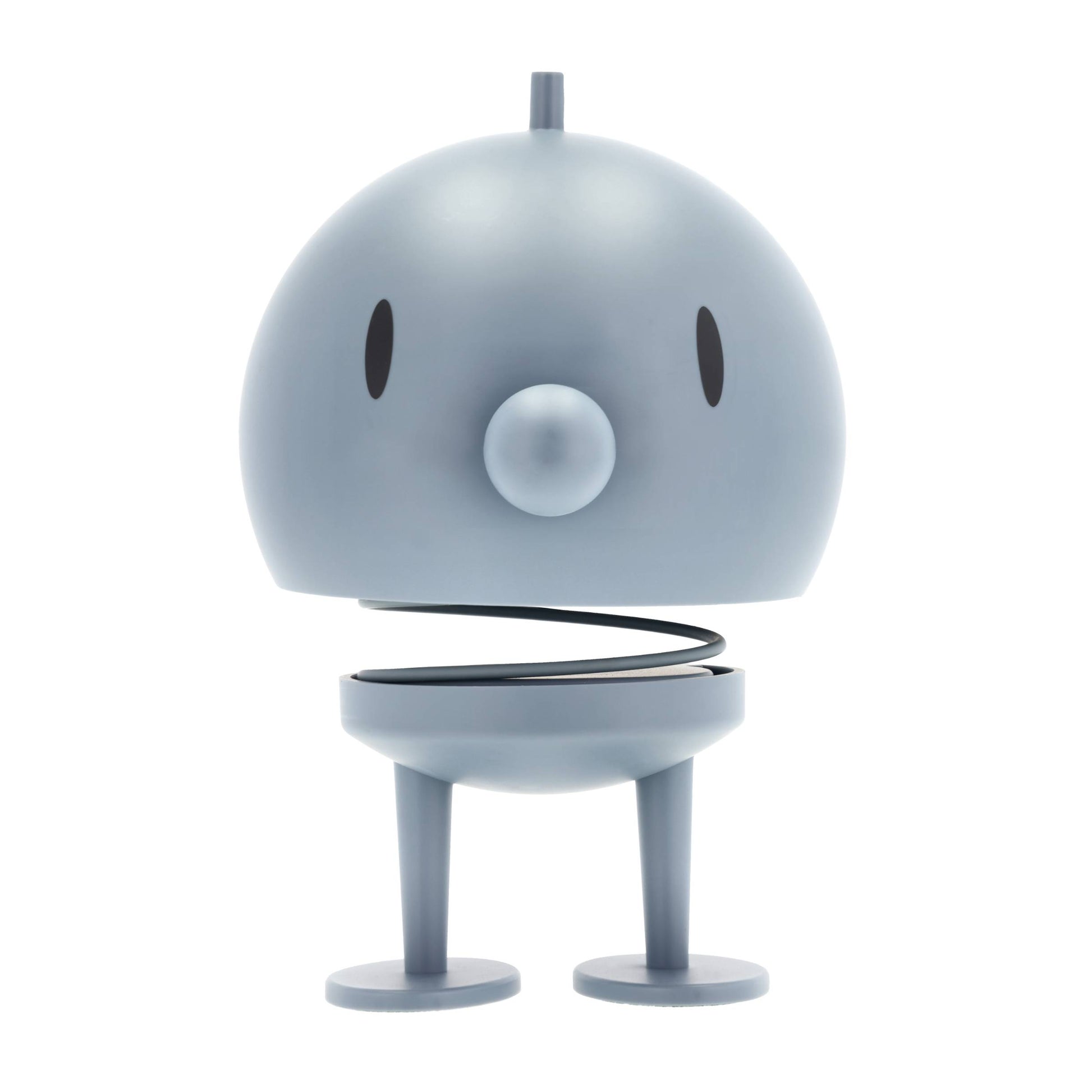 Small robot toy with a round body and legs on a white background